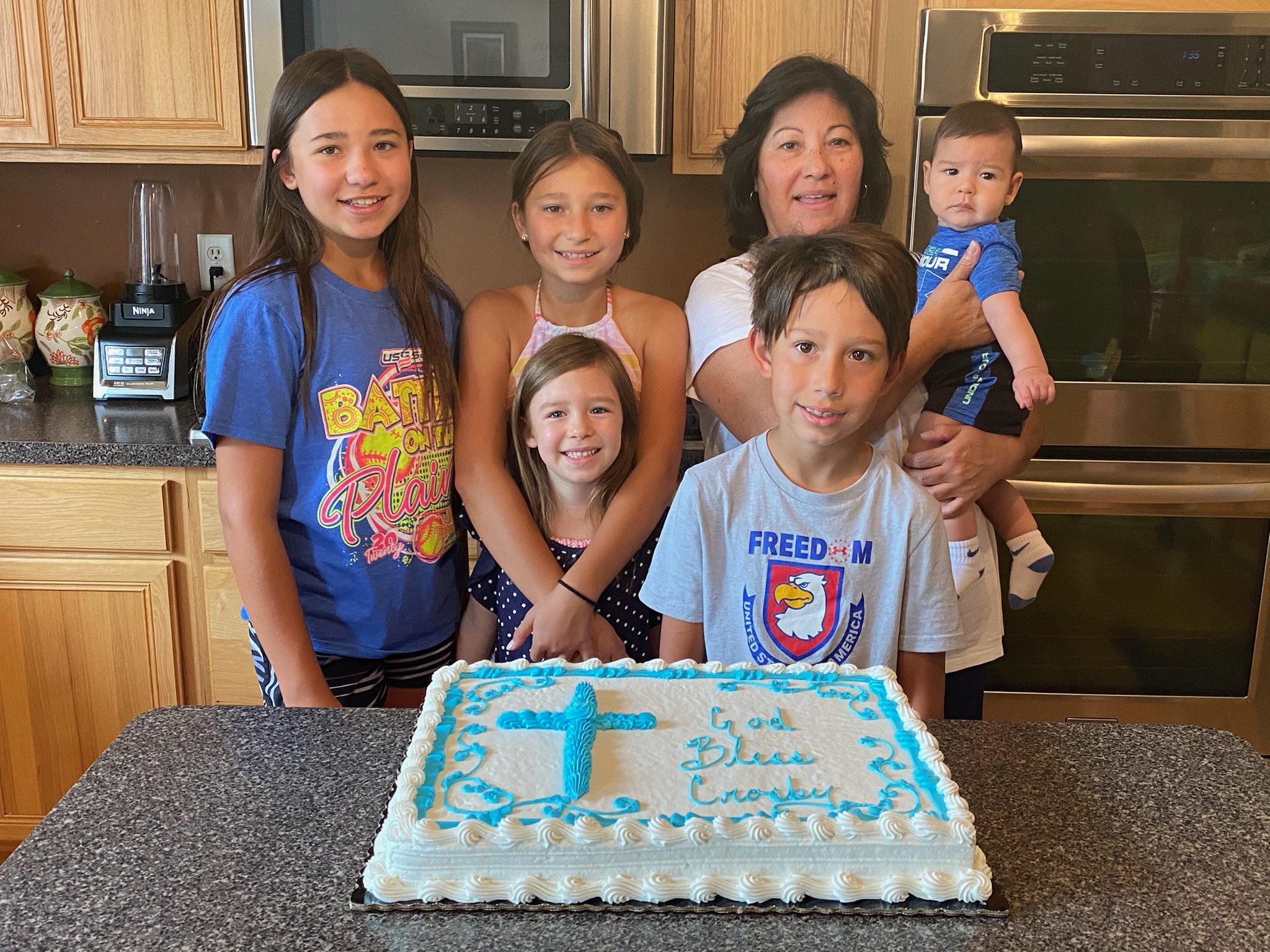 Tina Galindo et al. standing in front of a birthday cake